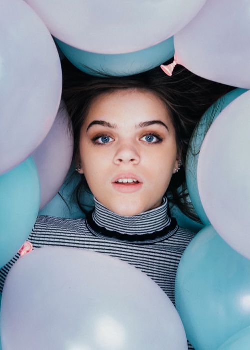 girl surrounded by ballons